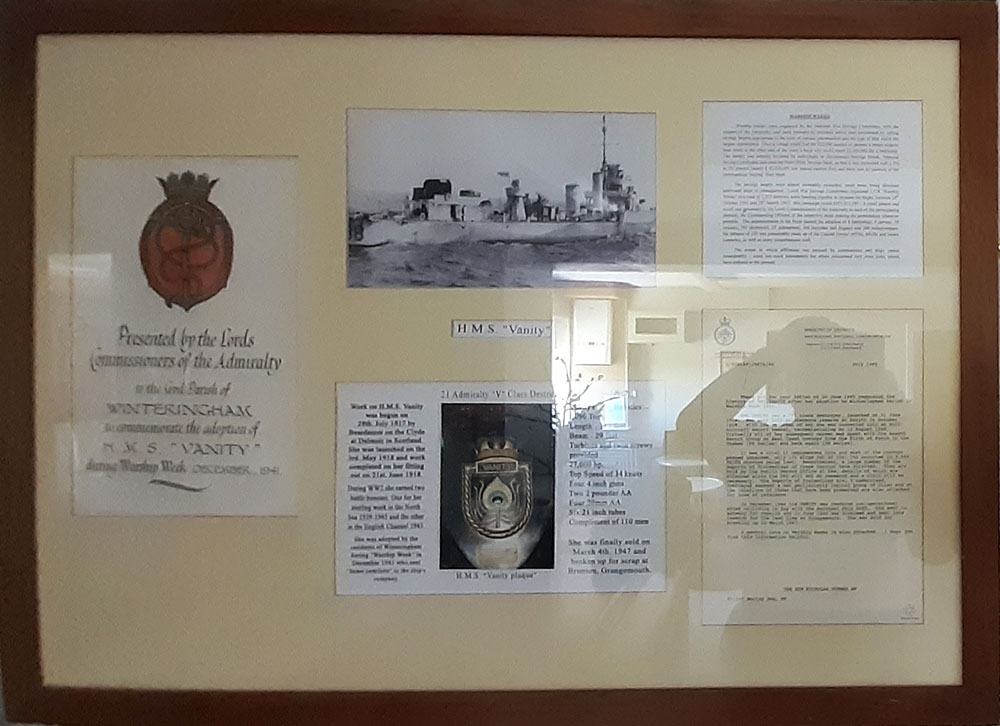 The framed scroll and other documents hanging in the village hall in Winteringham