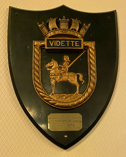 The creedt of HMS Vidette on its wooden shield presented by the ADmniralty to Todmorden