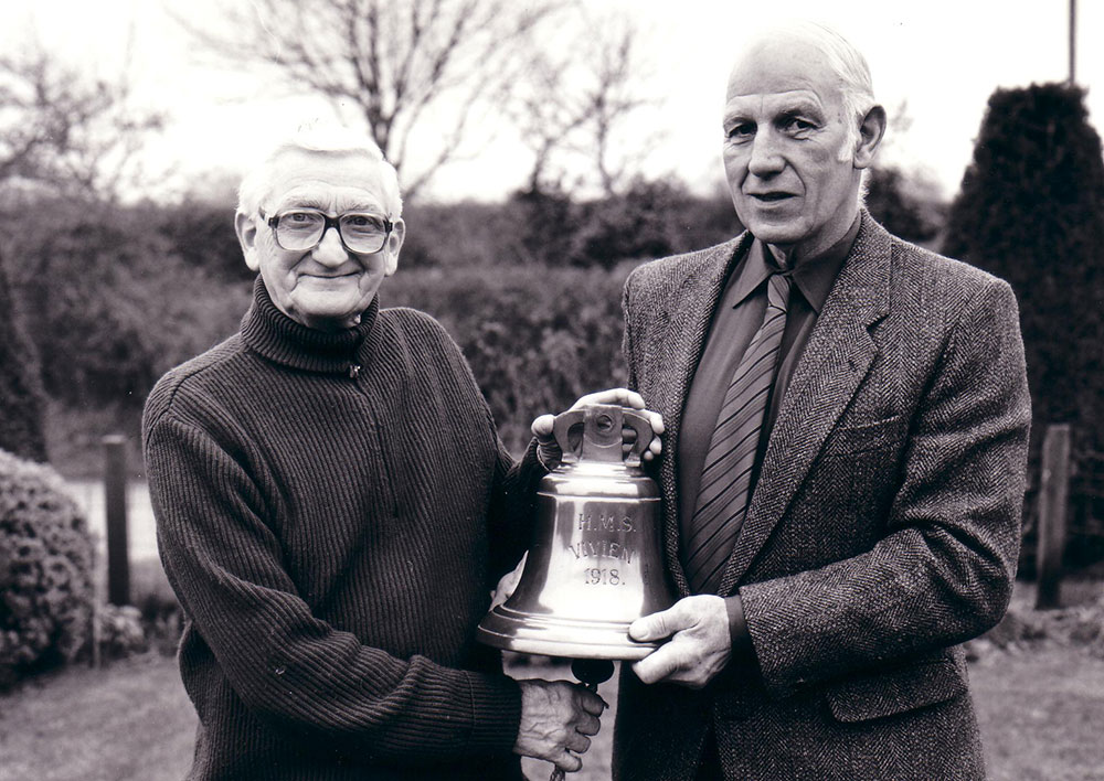 Arthur Taylor and shipmate Dick Fowler with the bell of HMS Vivien in 1994