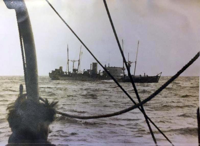 Merchant ship being escorted nrth by HMS Walker