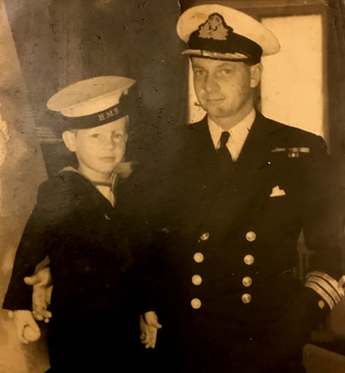Lt Cdr Cecil H Holmes with his son Japser in a sailor sduit