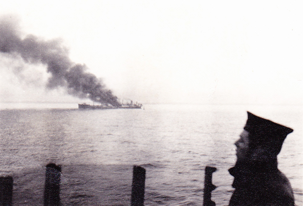 Merchant ship on fire from bridge of HMS Wolsey