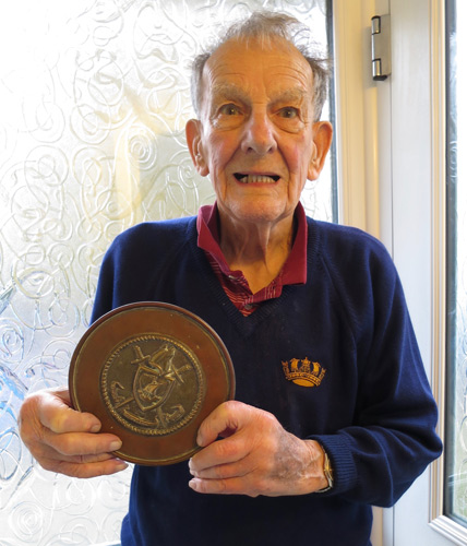 Frank Witton holding the tompion of his ship HMS Woolton