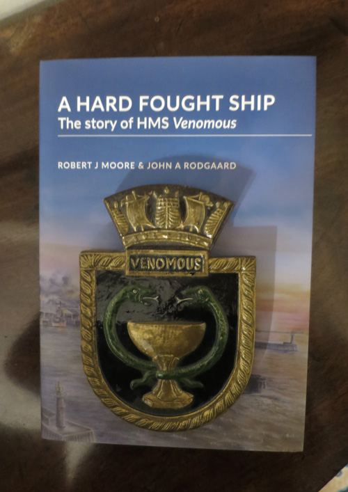 Crest of HMS Venomous photographed on the cover of A Hard Fought Ship (2017)